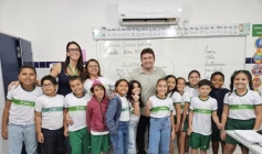 Helder ao lado de Bruna e alunos